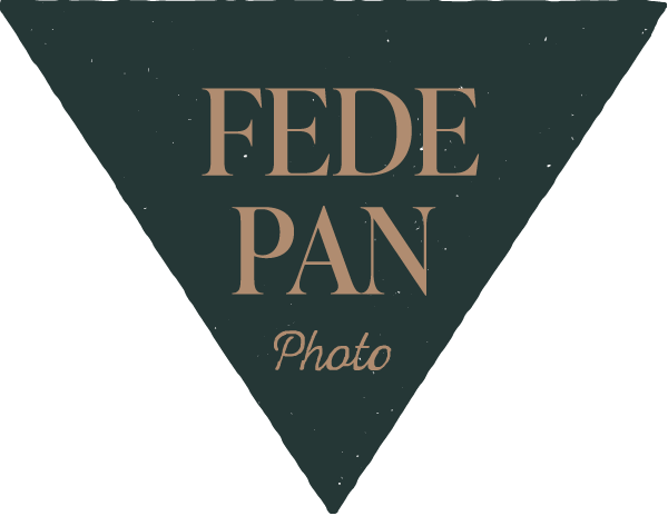 A dark green triangle points downward with the words FEDE PAN in large beige capital letters and Photo in smaller cursive script beneath, all centered on the triangle. The background is light gray. Tuscan Wedding Photographer